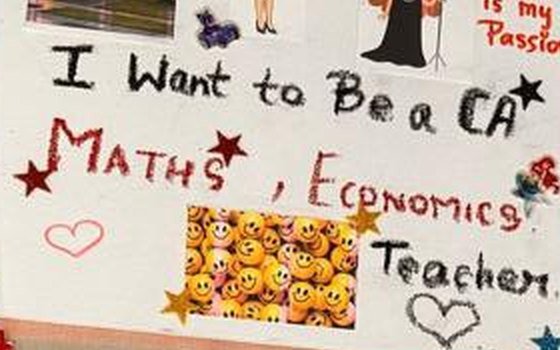 A vision board reading: I want to be a CA. Maths, Economics teacher. Decorated with stars and a patch of smiley face stickers.