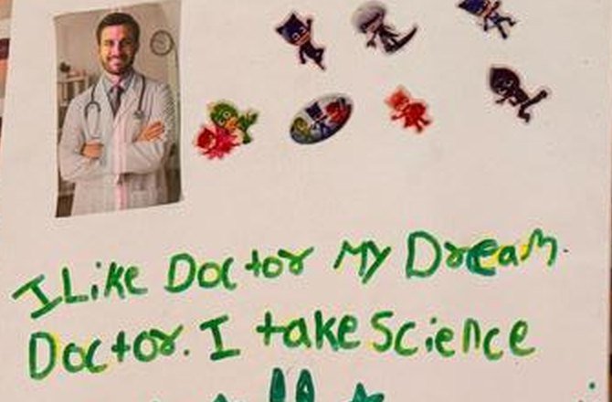 A vision board with a cut out photograph of a doctor, reading: I Like Doctor My Dream. Doctor. I take Science.